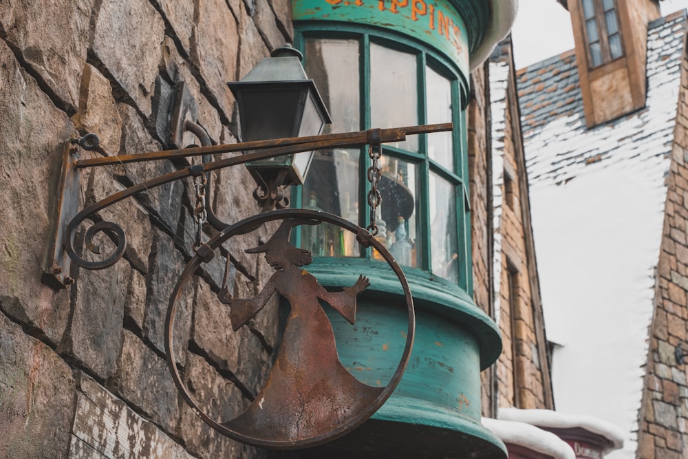 brown metal water pump on brown brick wall