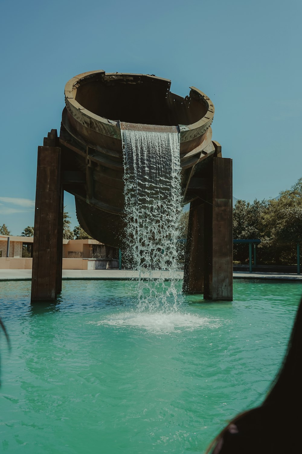 water fountain in the middle of the pool