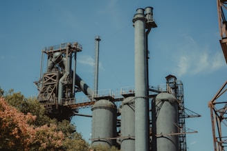 gray metal industrial machine near trees during daytime