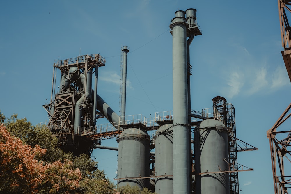 gray metal industrial machine near trees during daytime