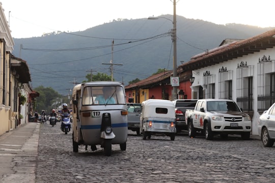 white and blue van on road during daytime in Antigua Guatemala Guatemala