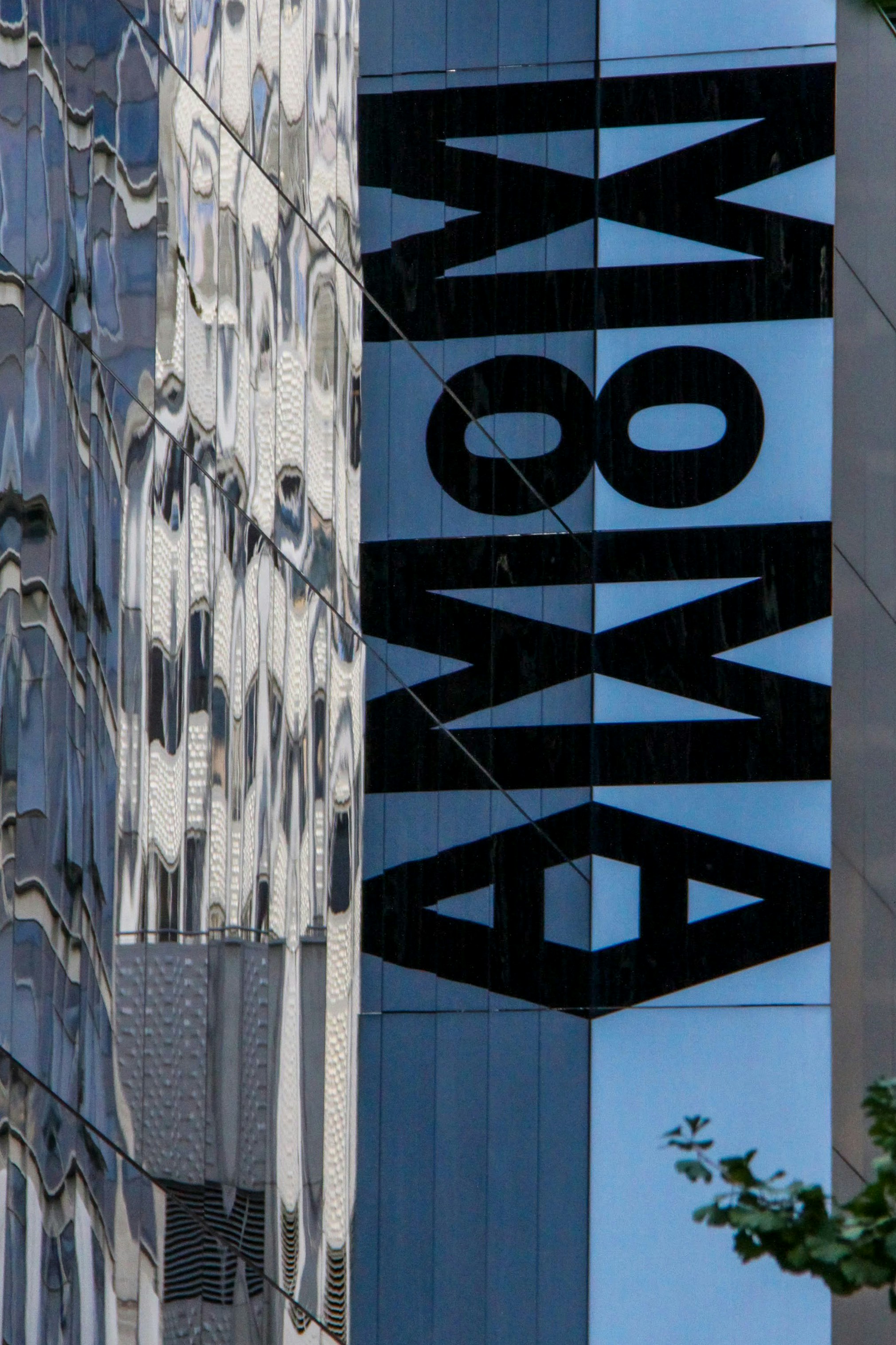The letters of the Museum Of Modern Art, reflected in the building’s windows.