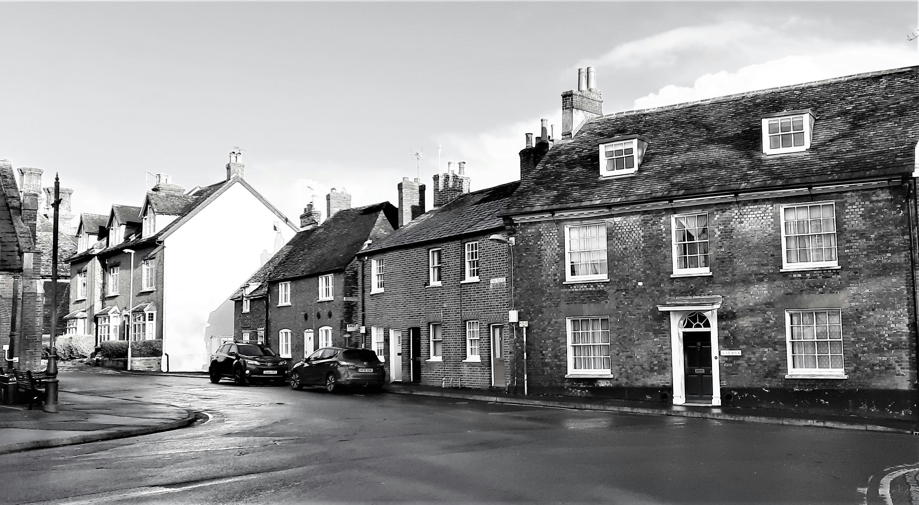 A small row of houses in Blandford Forum constructed after the last great fire with traditional Georgian architecture featuring red brick façades, construction est. 18th century. Image Captured 2021. 