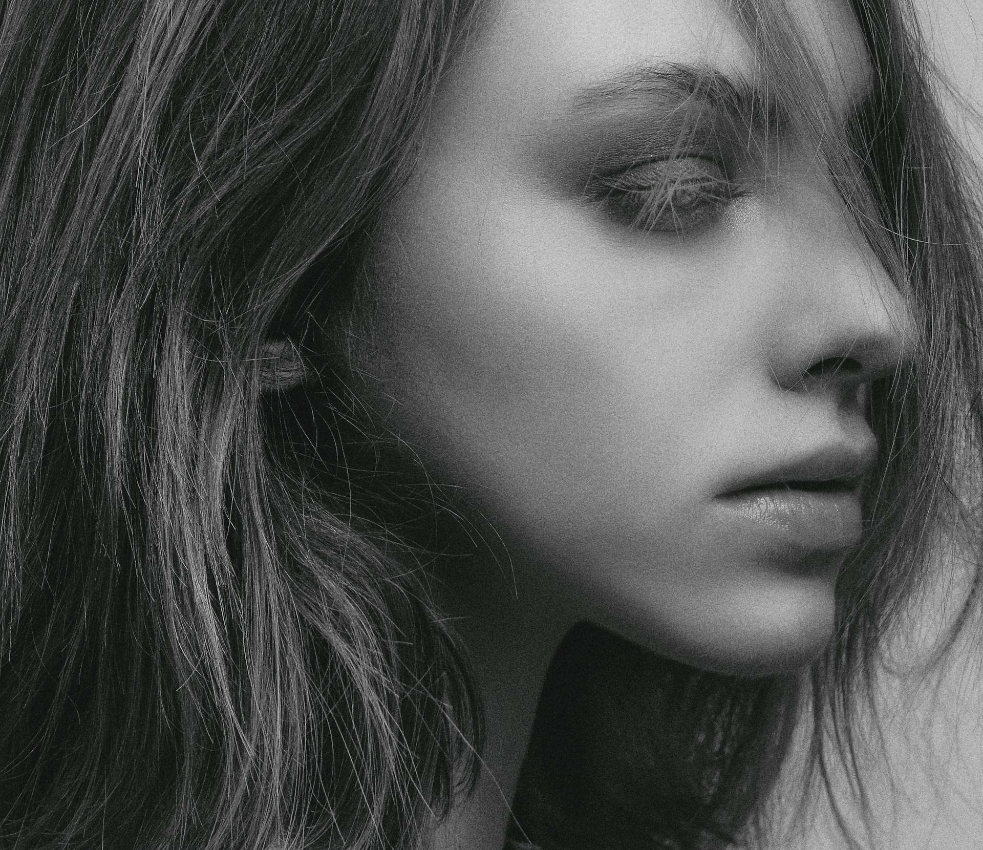 A striking before-and-after portrait showcasing natural skin retouching that enhances without losing character.