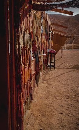 A colorful display of fashion and art products against a desert sand backdrop.