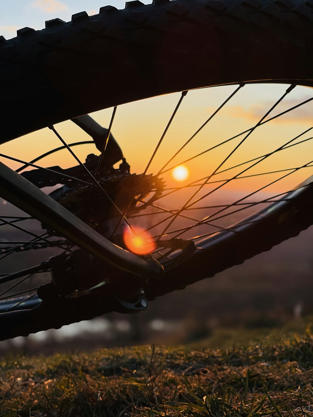 black bicycle wheel during sunset