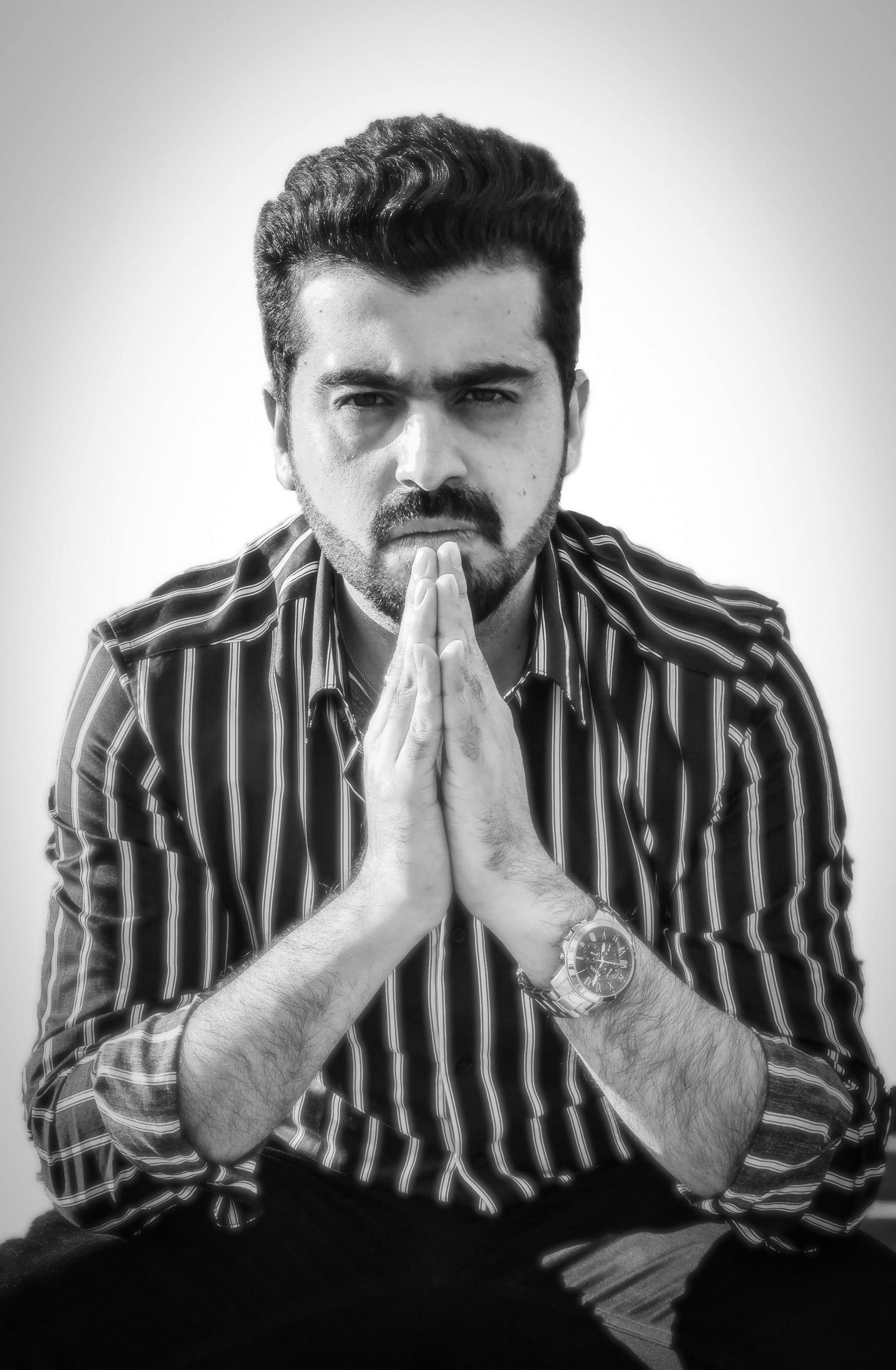 man in stripe shirt smoking cigarette