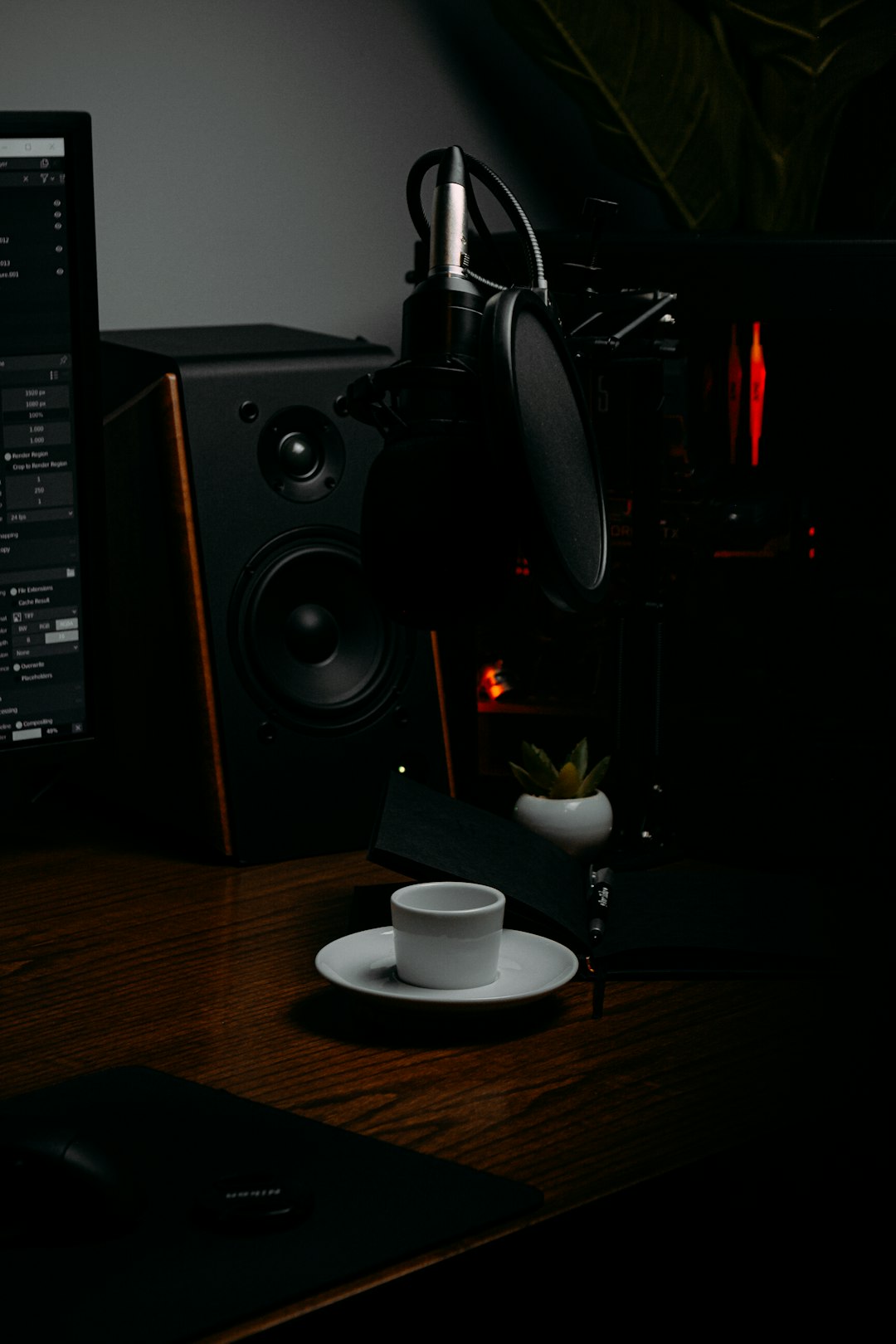 black and silver speaker on brown wooden table