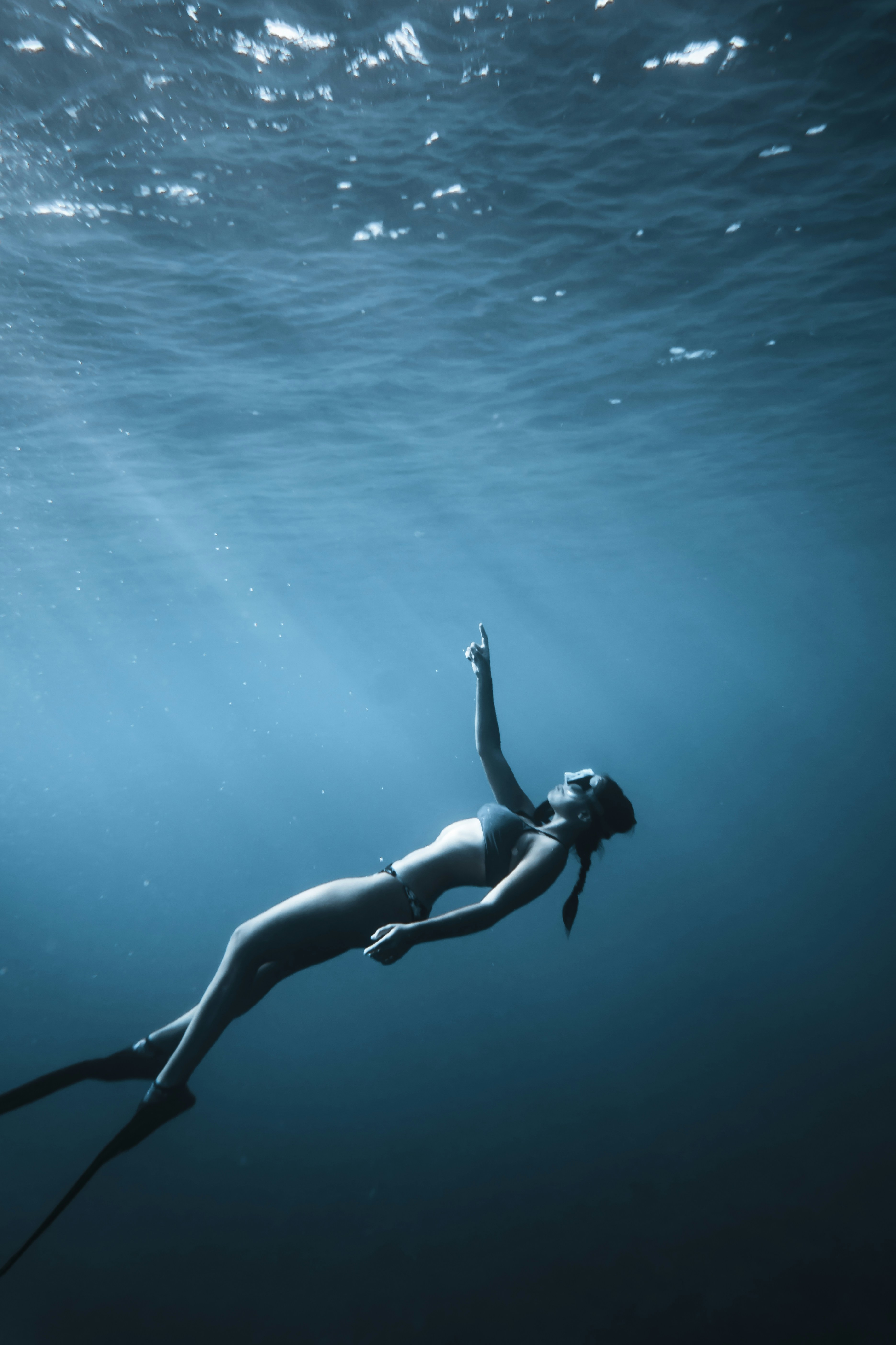 woman in black bikini swimming in the sea