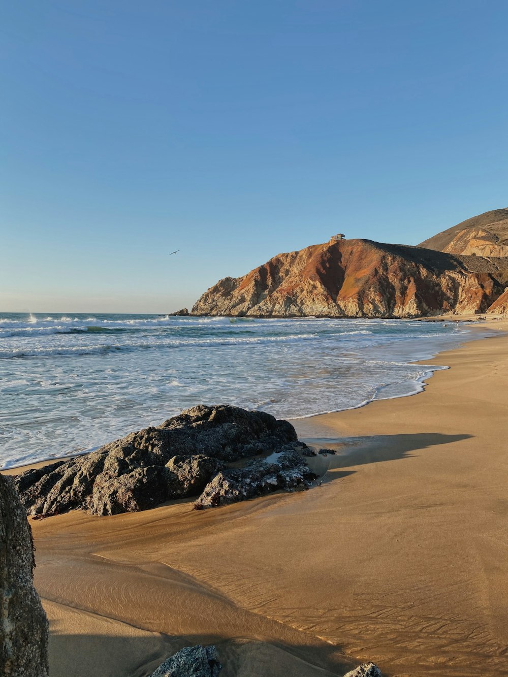 brown rock formation on sea shore during daytime