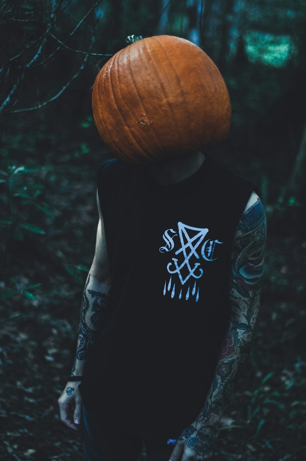 a man with a pumpkin on his head