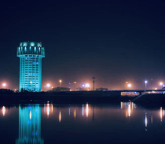 Night view of a fire water tank illuminated by safety lights, emphasizing reliability in emergencies.