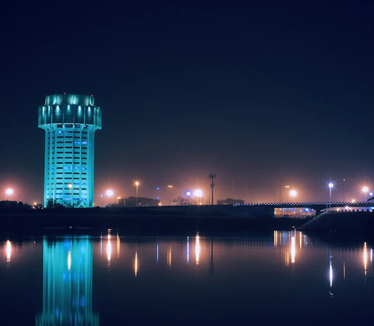 Night view of a fire water tank illuminated by safety lights, emphasizing reliability in emergencies.