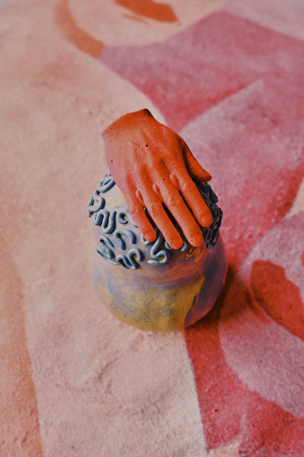 person holding blue and white ceramic vase