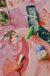 green bic lighter beside clear glass ashtray