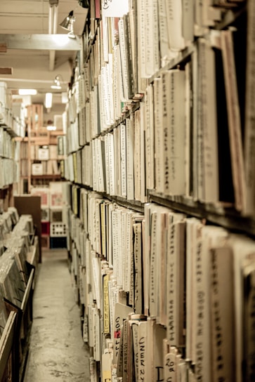 white and black labeled books on shelf