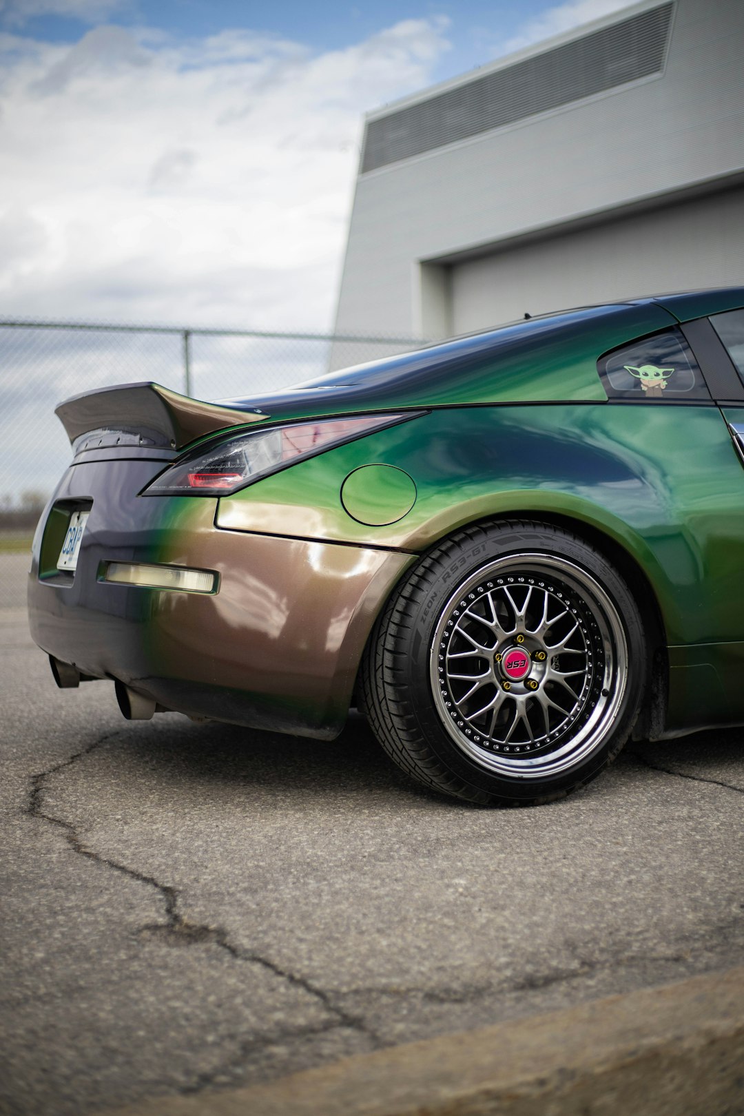 green porsche 911 parked on gray pavement