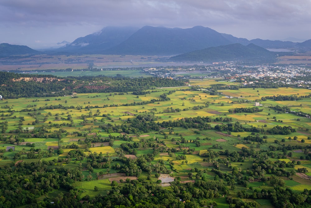 green grass field near mountain during daytime