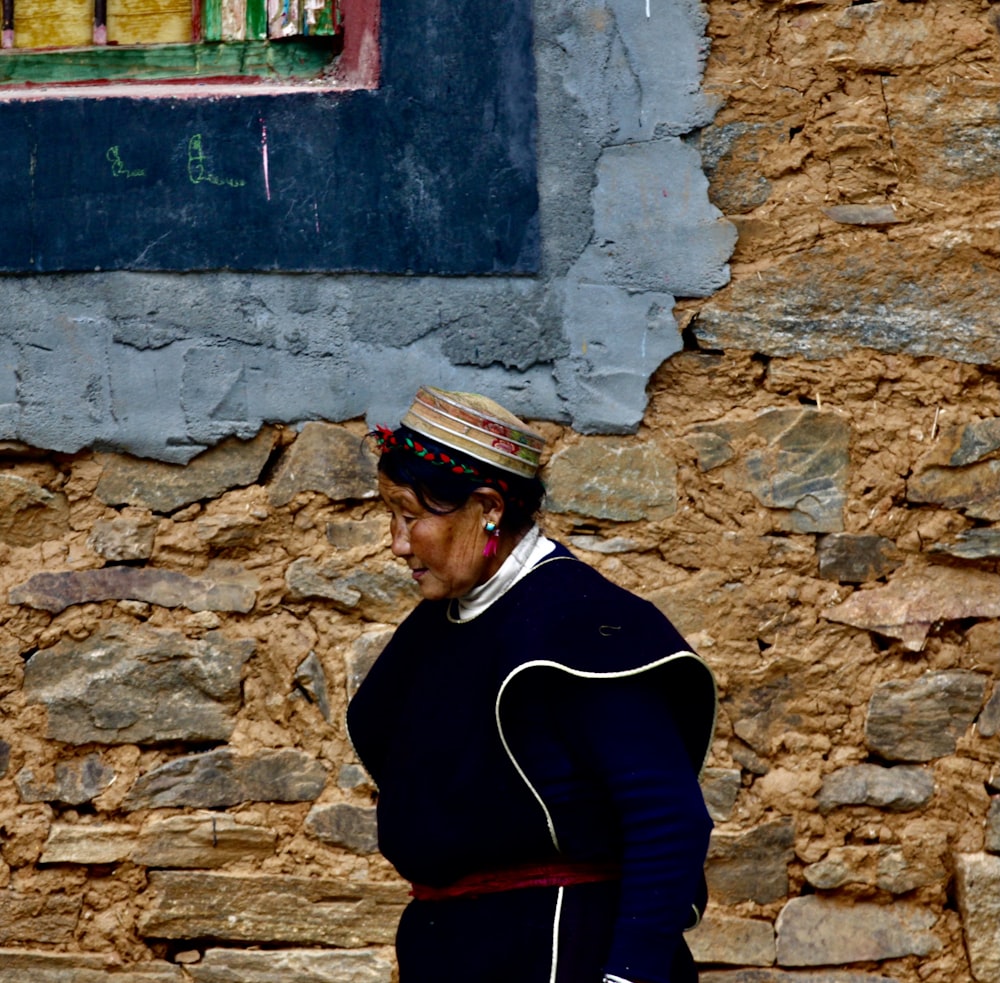 man in black jacket wearing white and black cap