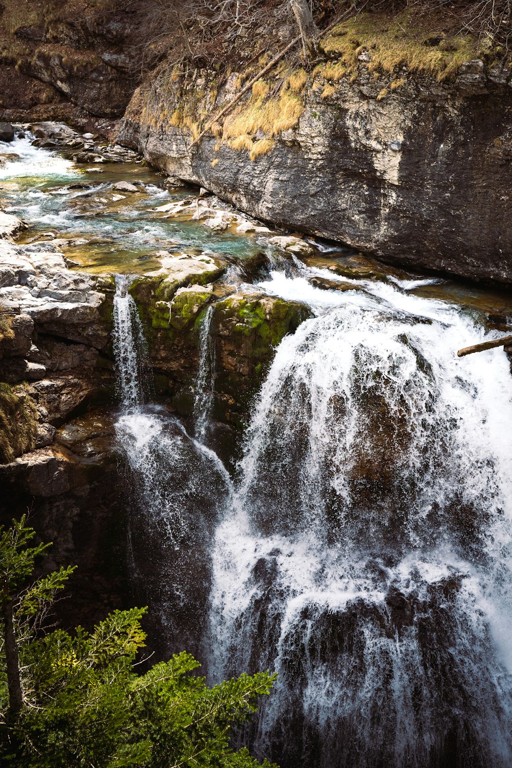 water falls on brown rocky mountain