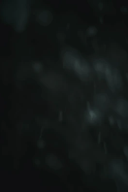 An abstract, dark-hued network grid fading into deep charcoal darkness.