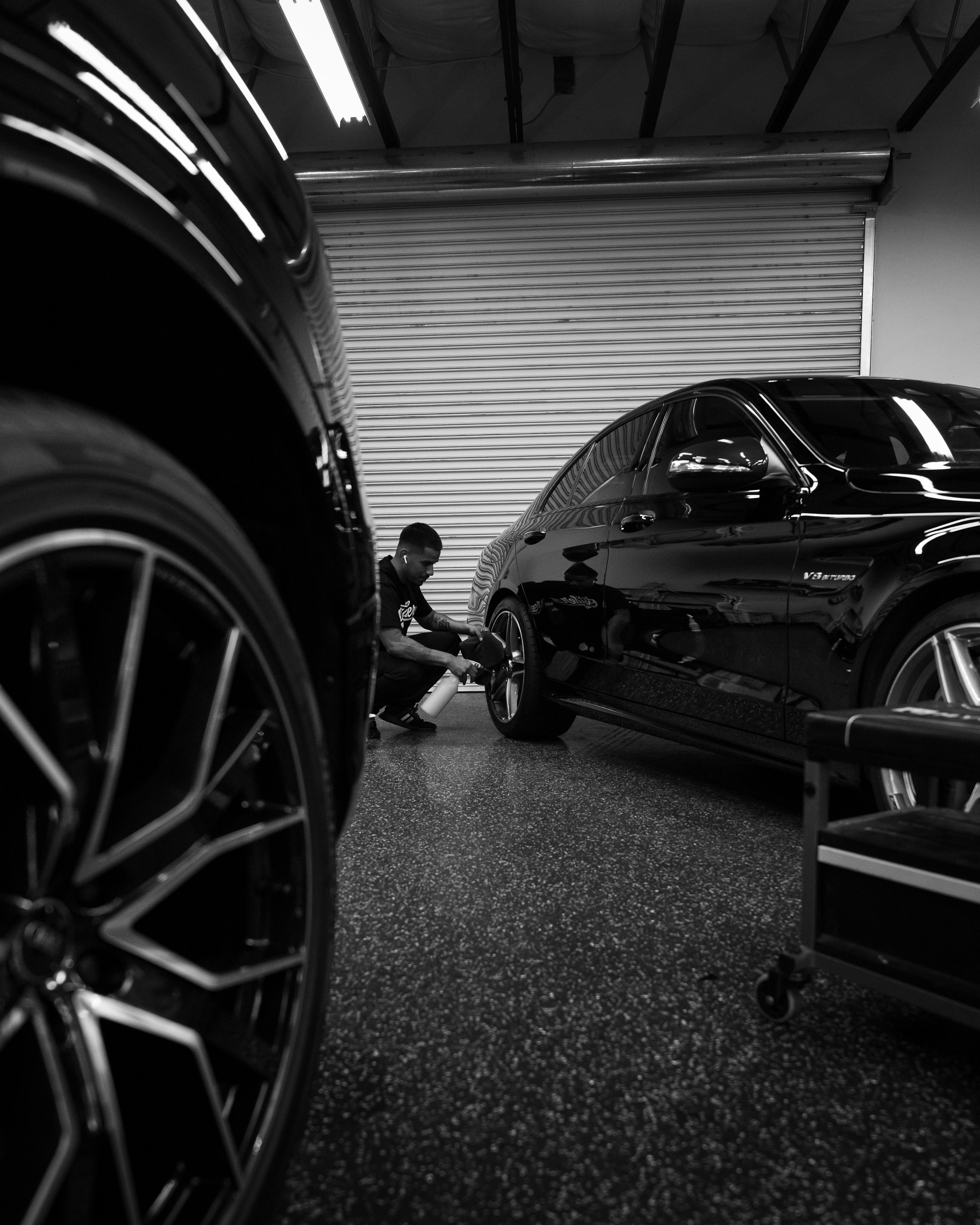 Luxury car owner inspecting vehicle before shipping