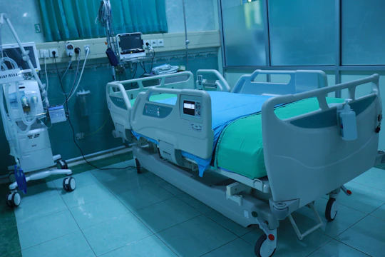 A sleek motorized ICU bed with safety-lock and Trendelenburg features in a modern hospital room.