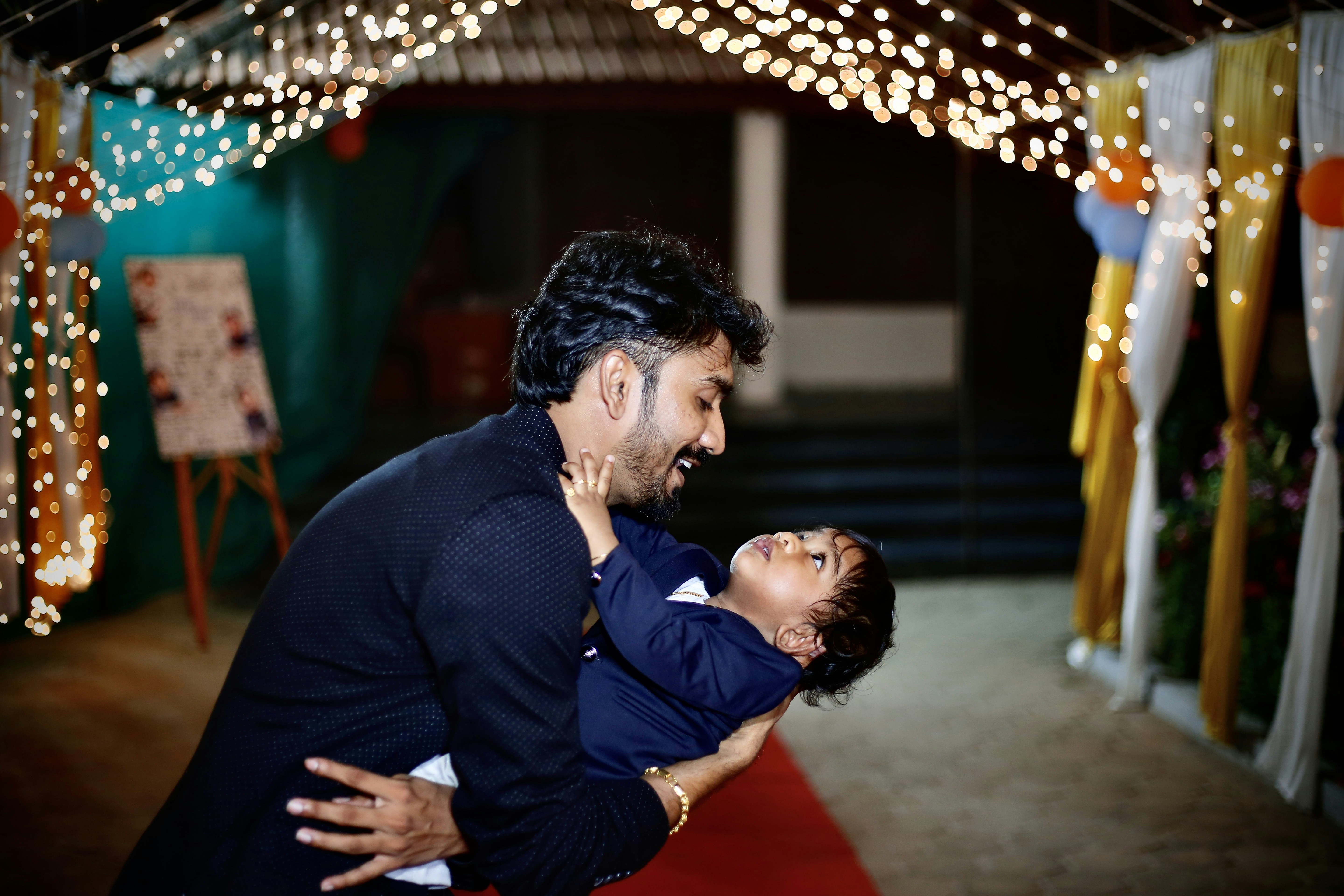 man in black suit kissing woman in red dress