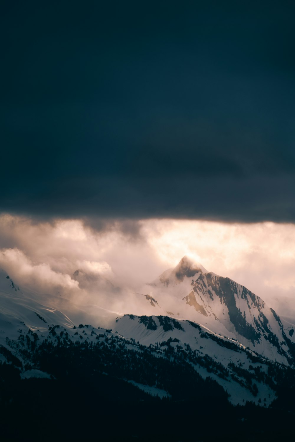 snow covered mountain under cloudy sky during daytime