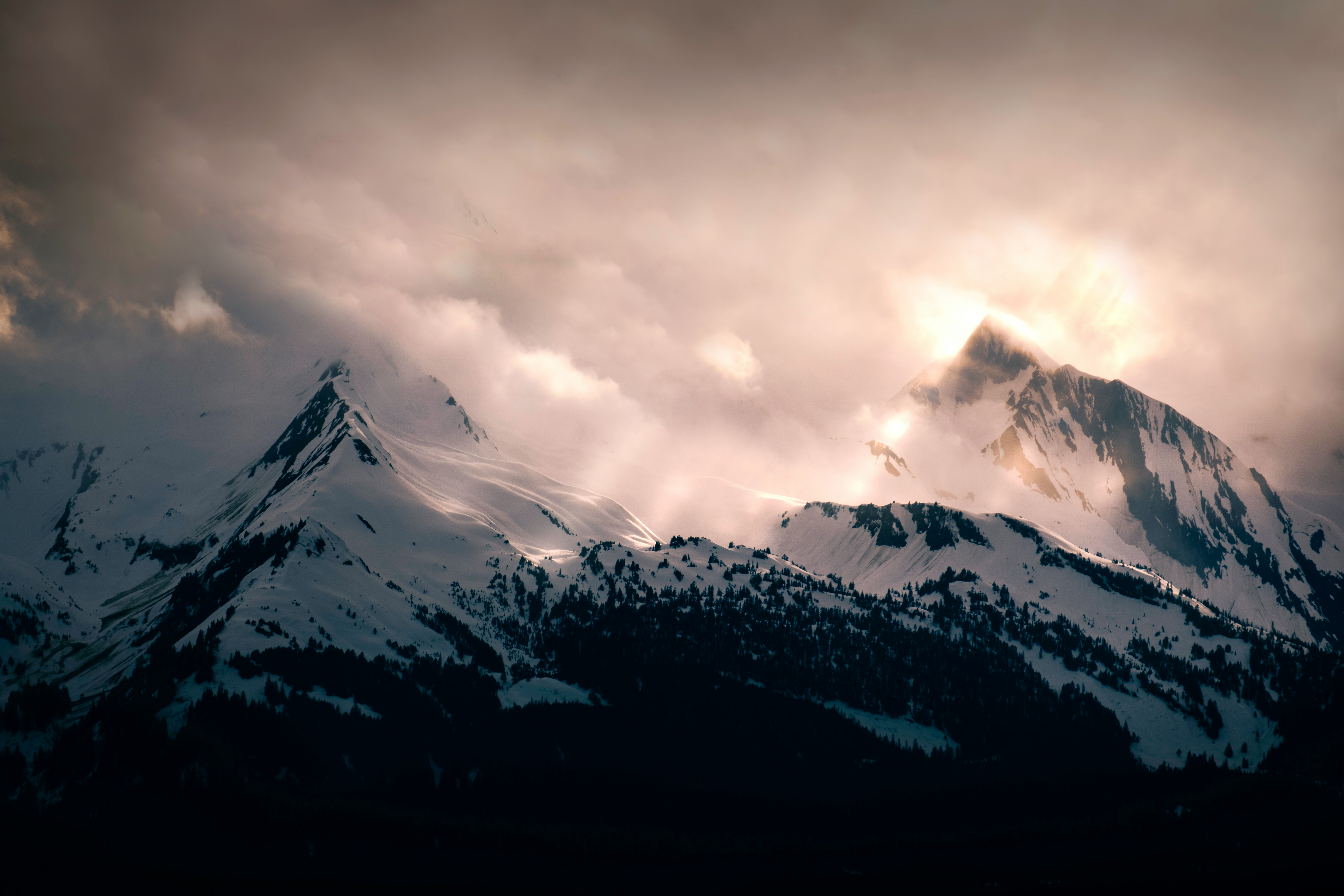 snow covered mountain under cloudy sky during daytime