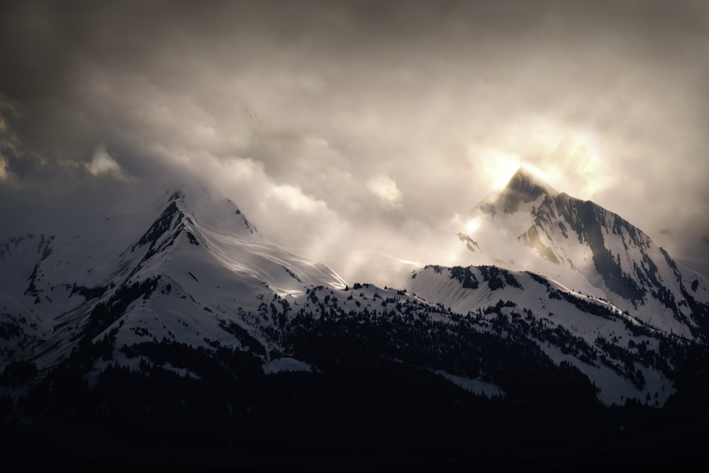 snow covered mountain under cloudy sky during daytime