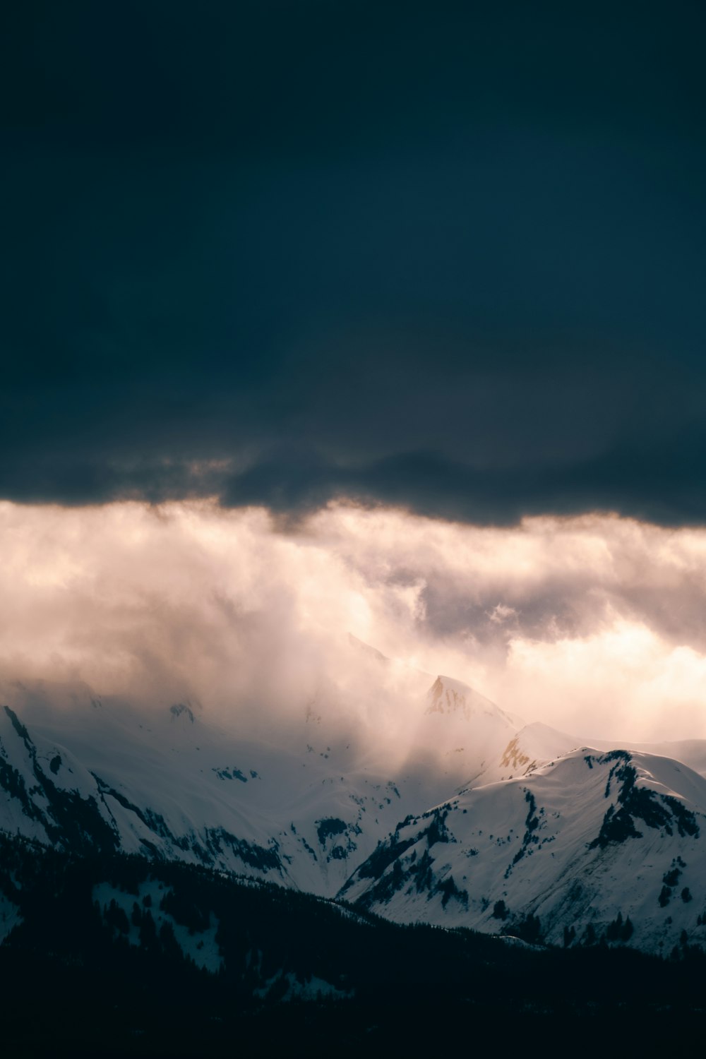 snow covered mountain under cloudy sky