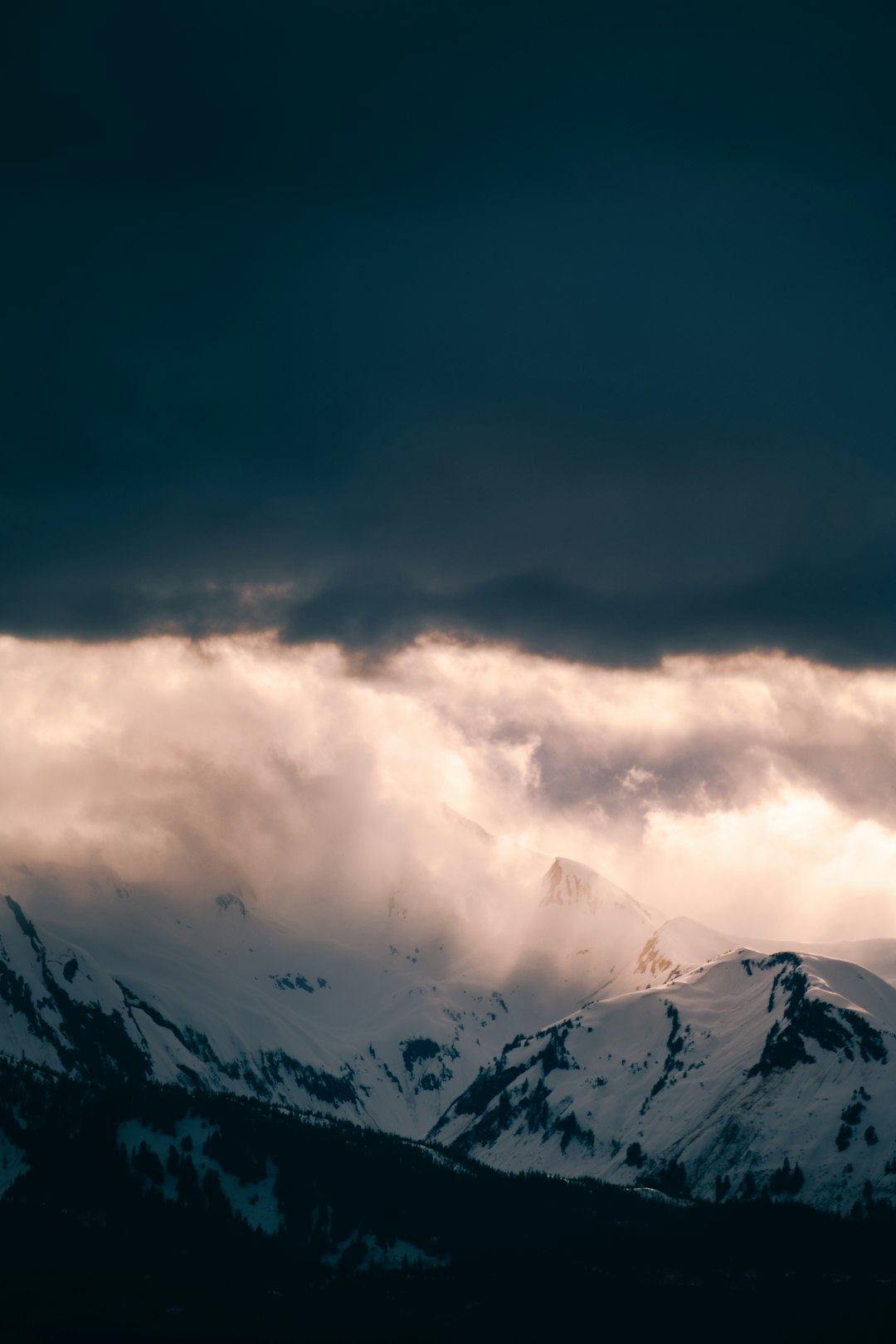 snow covered mountain under cloudy sky