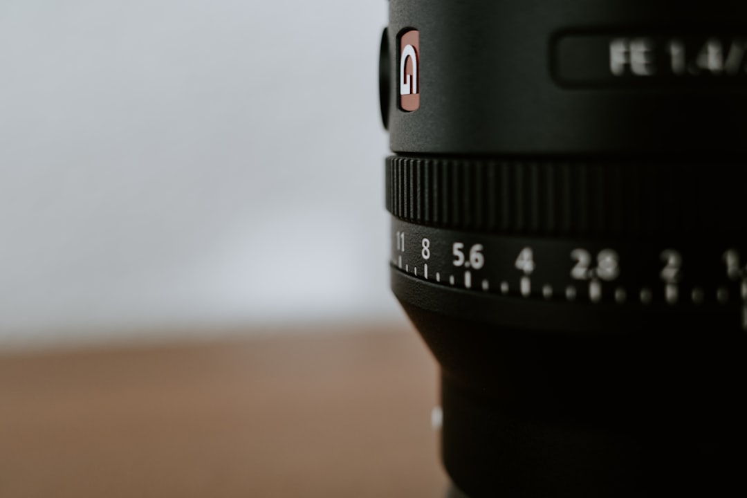 black camera lens on brown wooden table