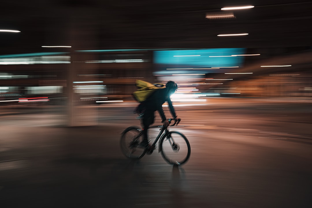 man in yellow shirt riding bicycle