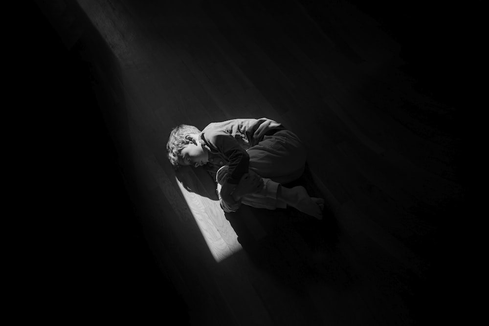 man in black jacket and pants sitting on stairs