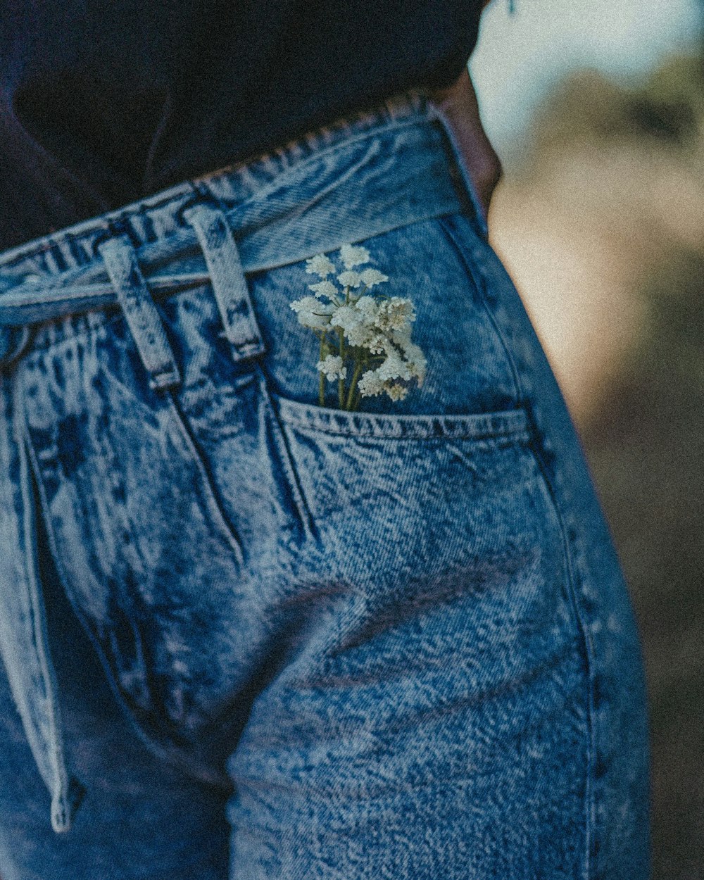 blue denim jeans on black textile