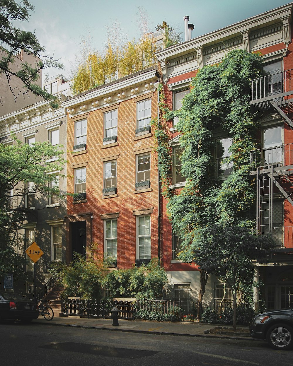 brown concrete building near green trees during daytime