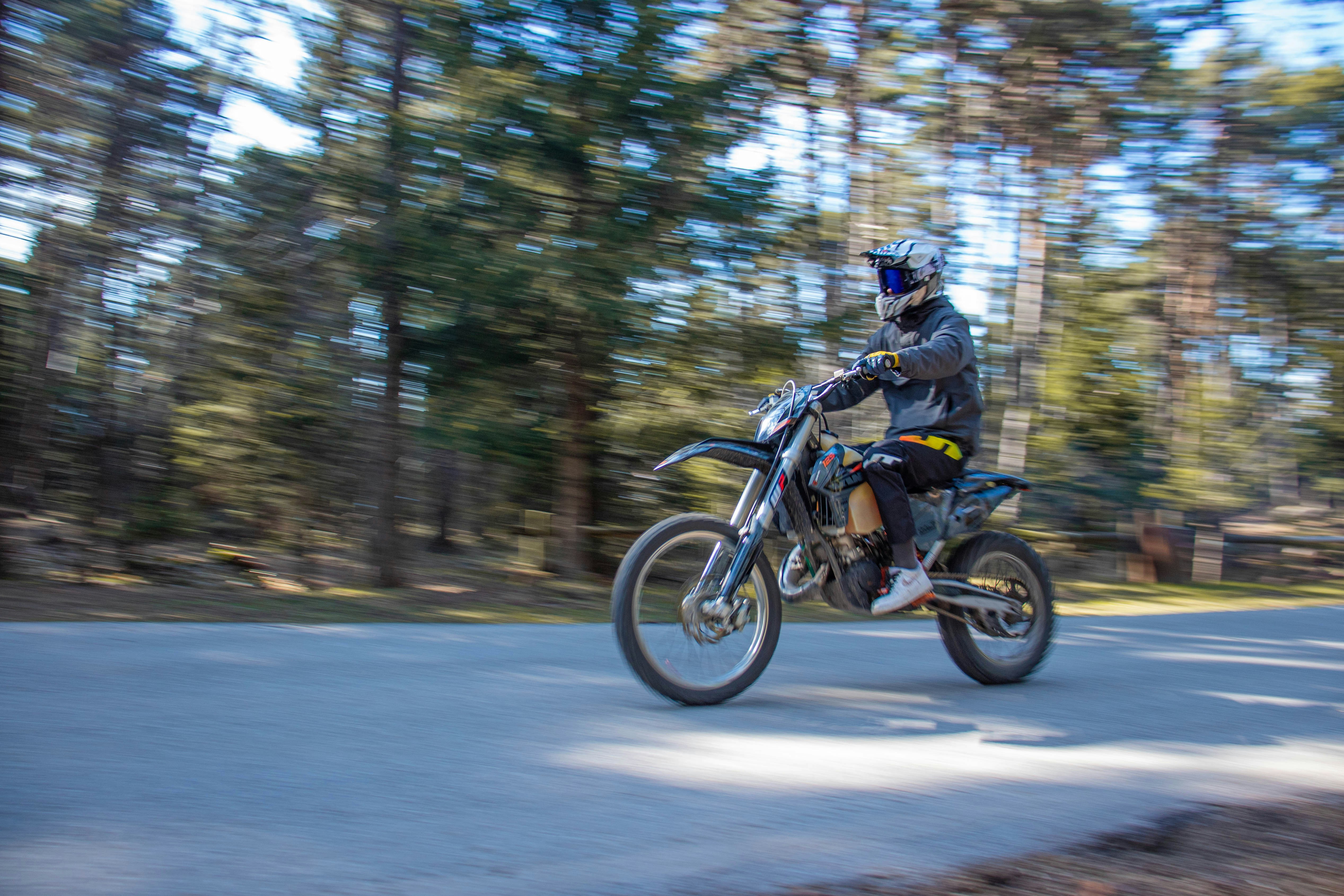 man riding motorcycle on road during daytime