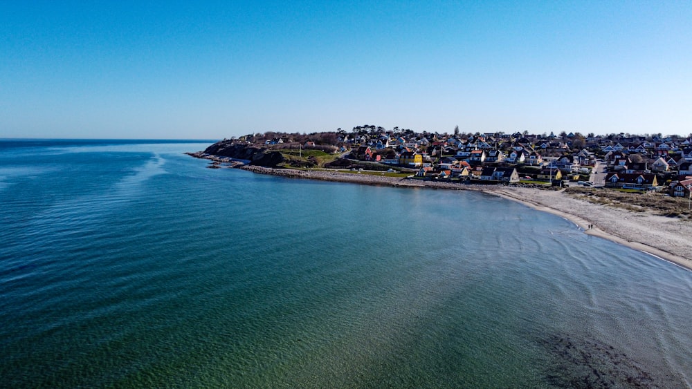 houses near sea under blue sky during daytime