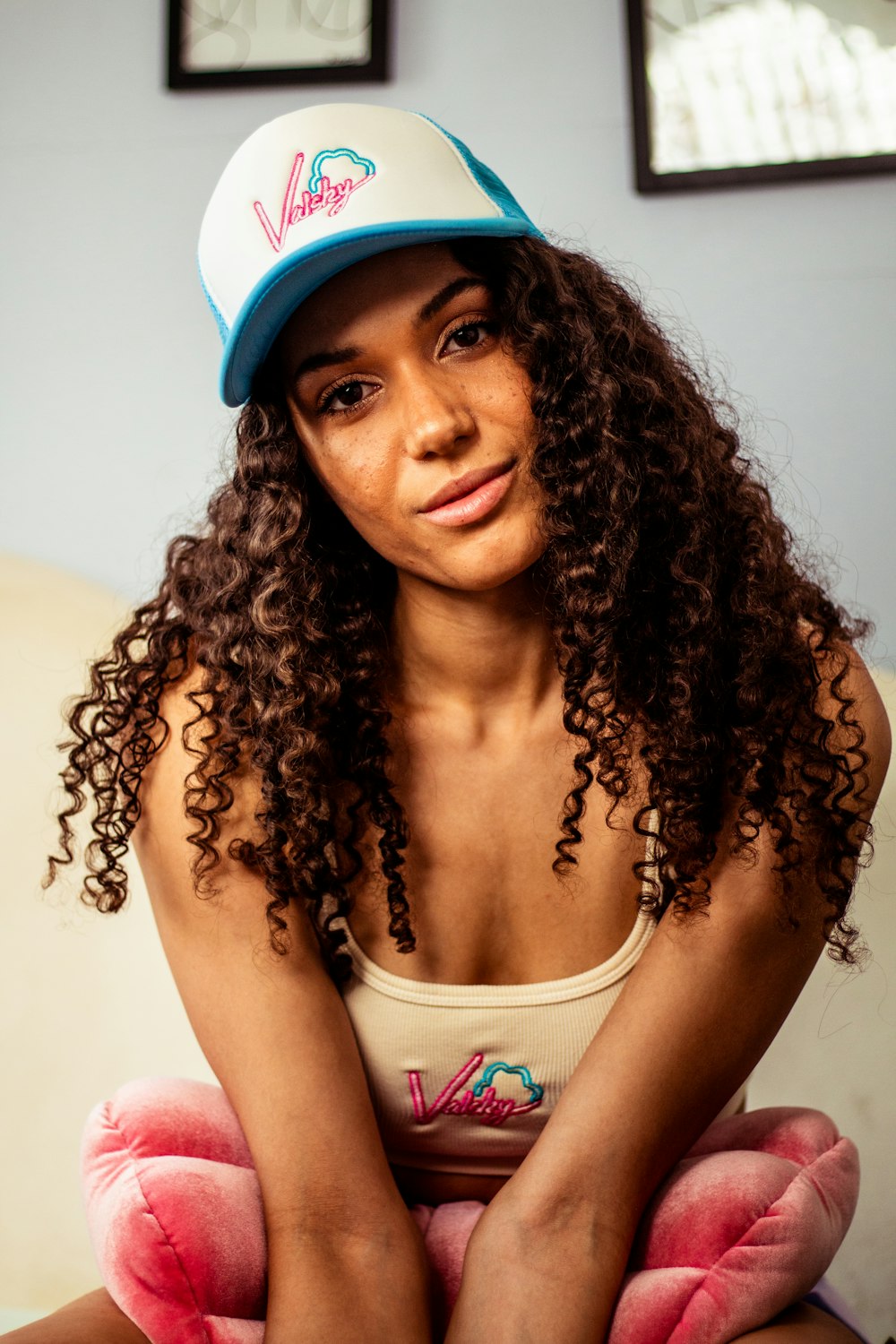 woman in white tank top wearing blue and white cap