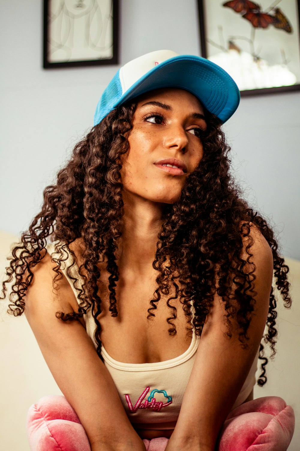 woman in white tank top wearing blue cap