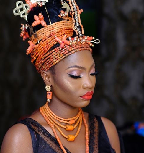 woman in orange and black floral headdress