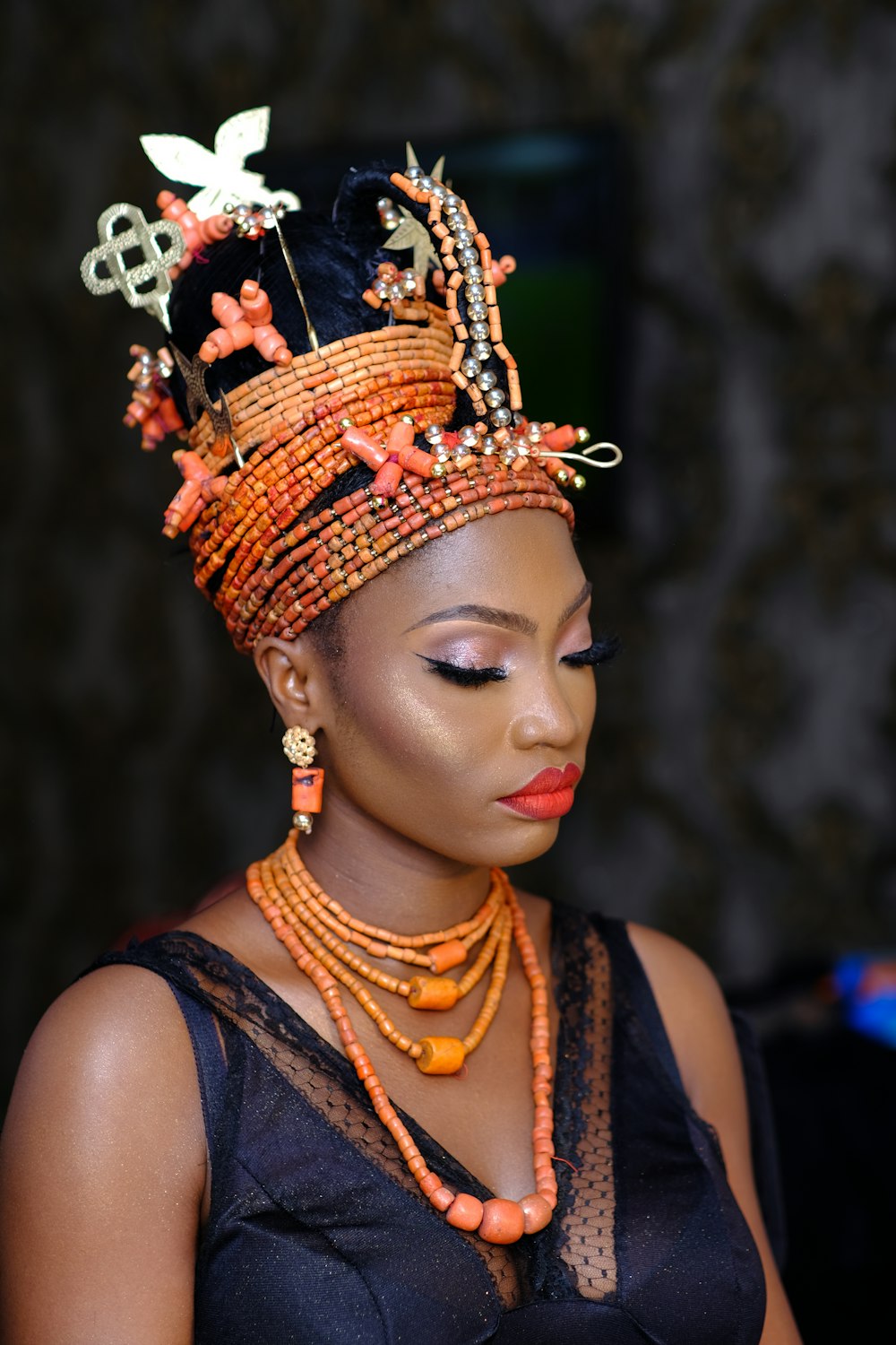 woman in orange and black floral headdress