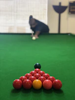Close-up of a snooker table with balls perfectly arranged, ready for a match at LevelUp Cafe.