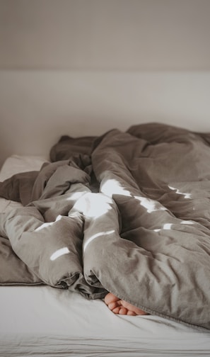 brown and white bed linen