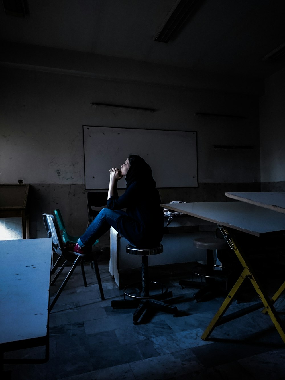 woman in black long sleeve shirt sitting on black chair