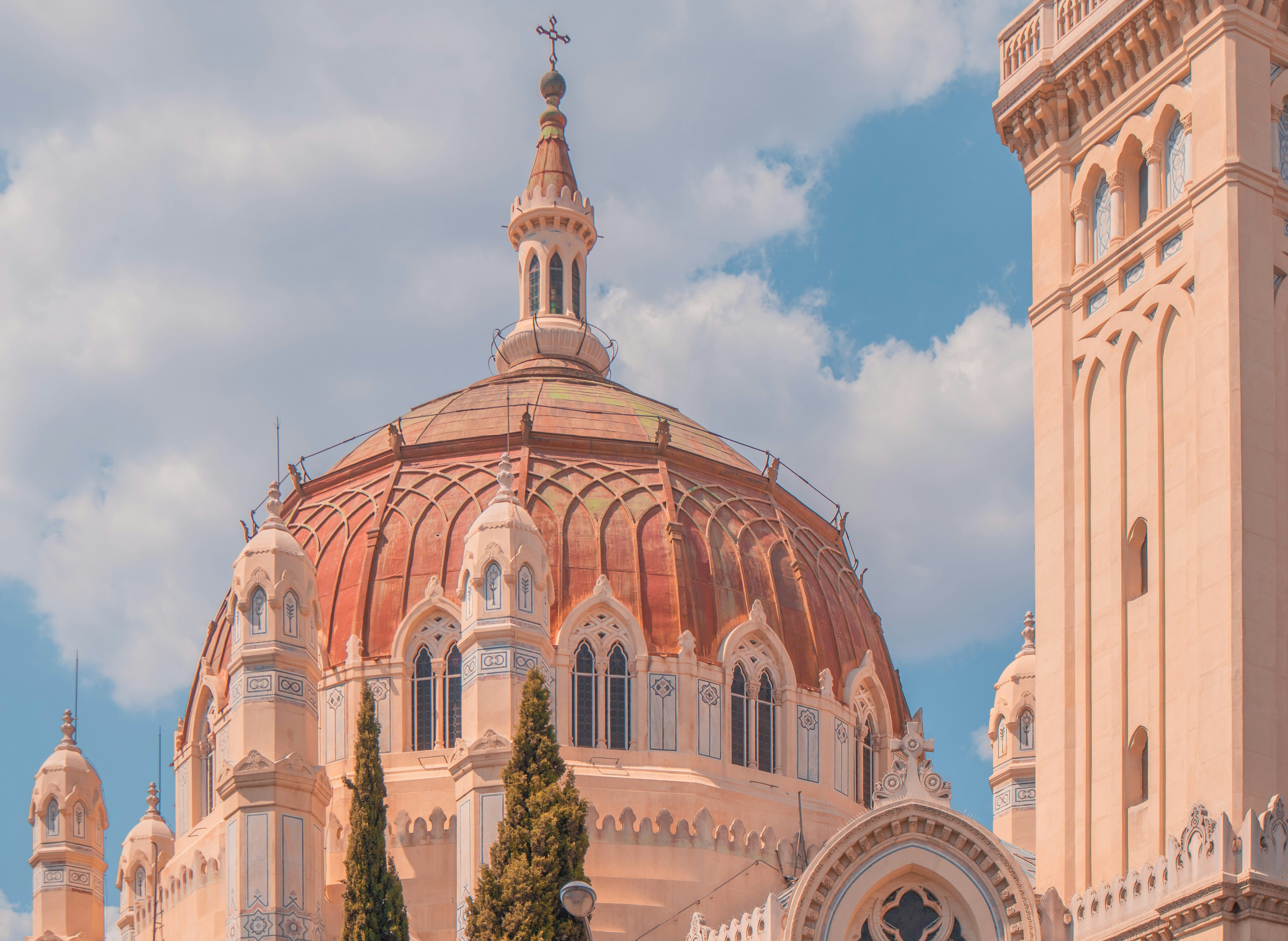 brown and white concrete dome building under blue sky during daytime