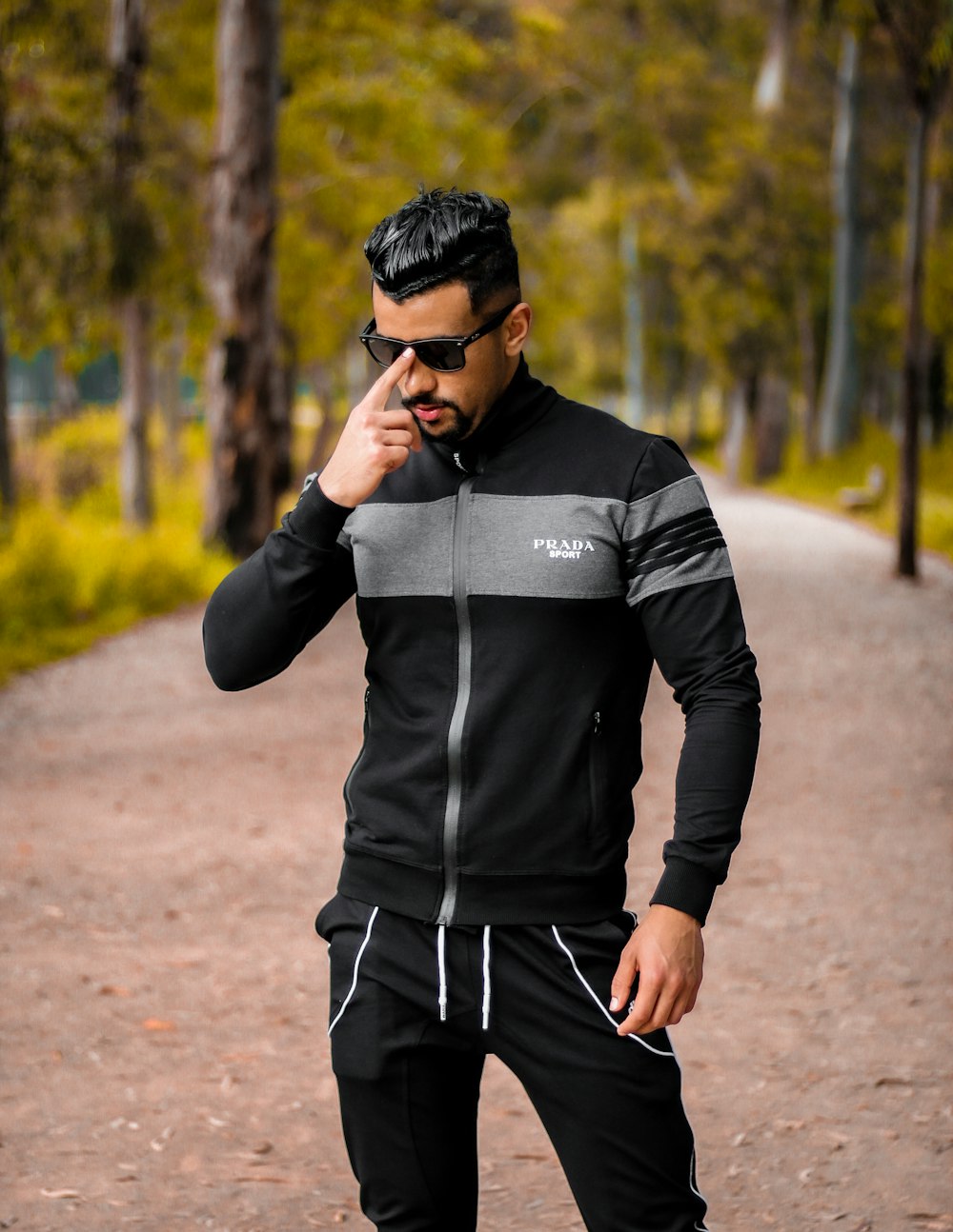 man in black leather jacket and black and white striped pants standing on  road during daytime photo – Free Rabat Image on Unsplash