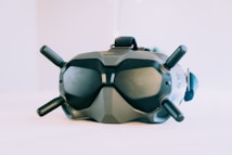 A high-tech virtual reality headset with four antennas protruding from its sides and top. The device has a sleek, matte finish and an ergonomic design for comfortable wear. It appears to have various adjustment mechanisms and buttons, indicating advanced functionality.